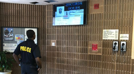 police officer in lobby viewing screensaver